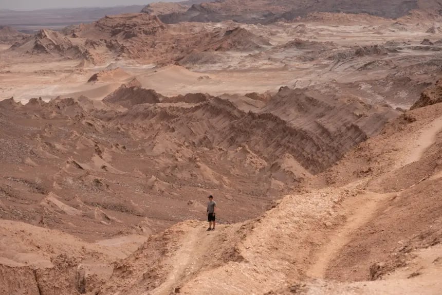 Man admiring the views in the middle of the Moon Valley in the Atacama Desert